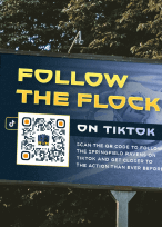QR Code on an airline's website homepage prompting people to scan to download their app.